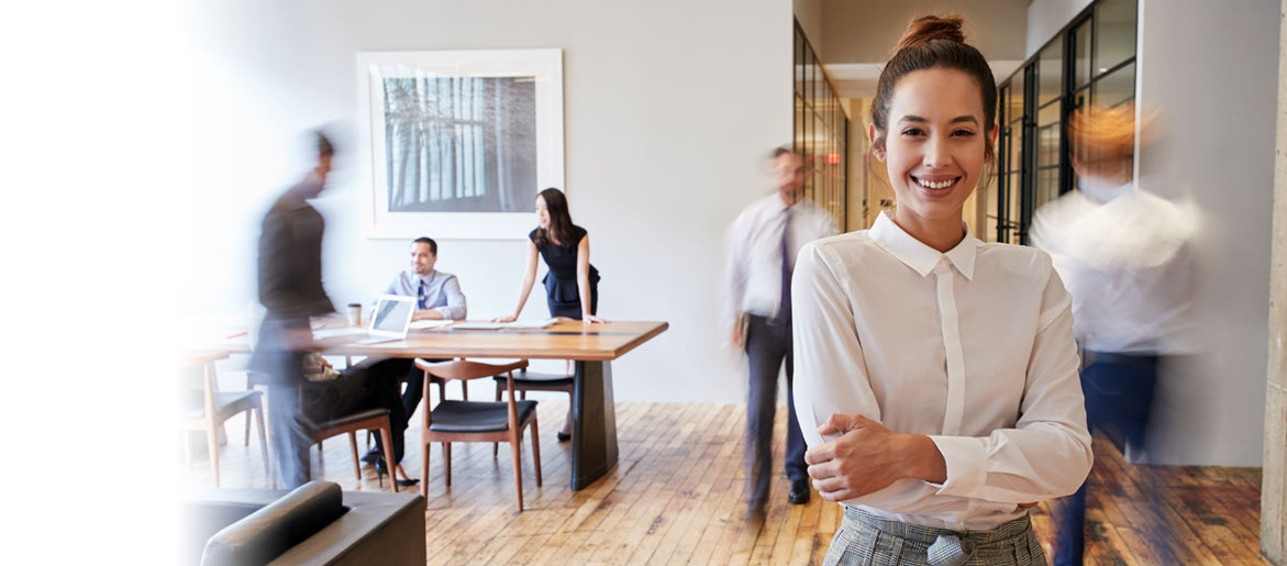 Girl standing in busy work office